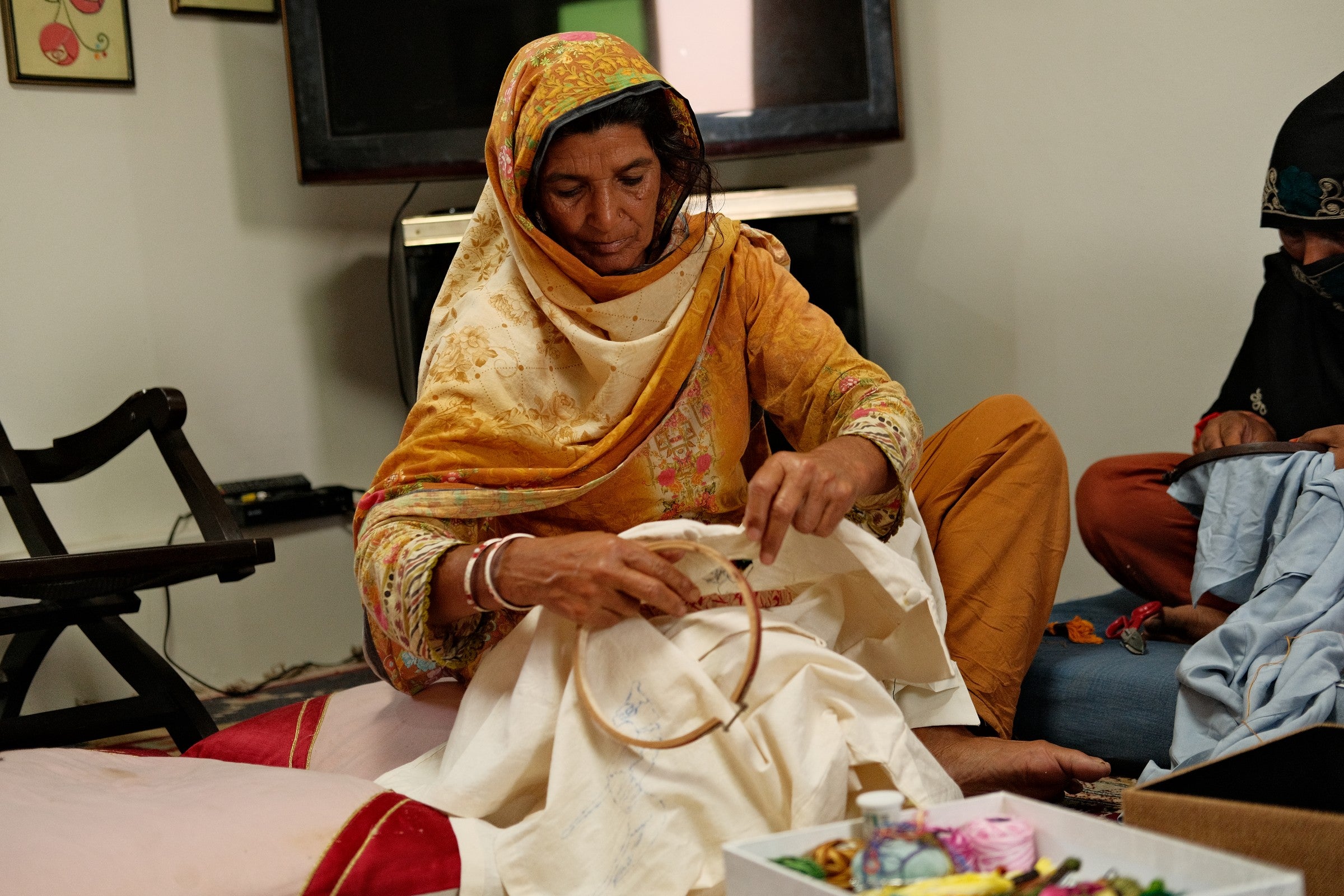 Portrait of an artisan holding an embroidery hoop