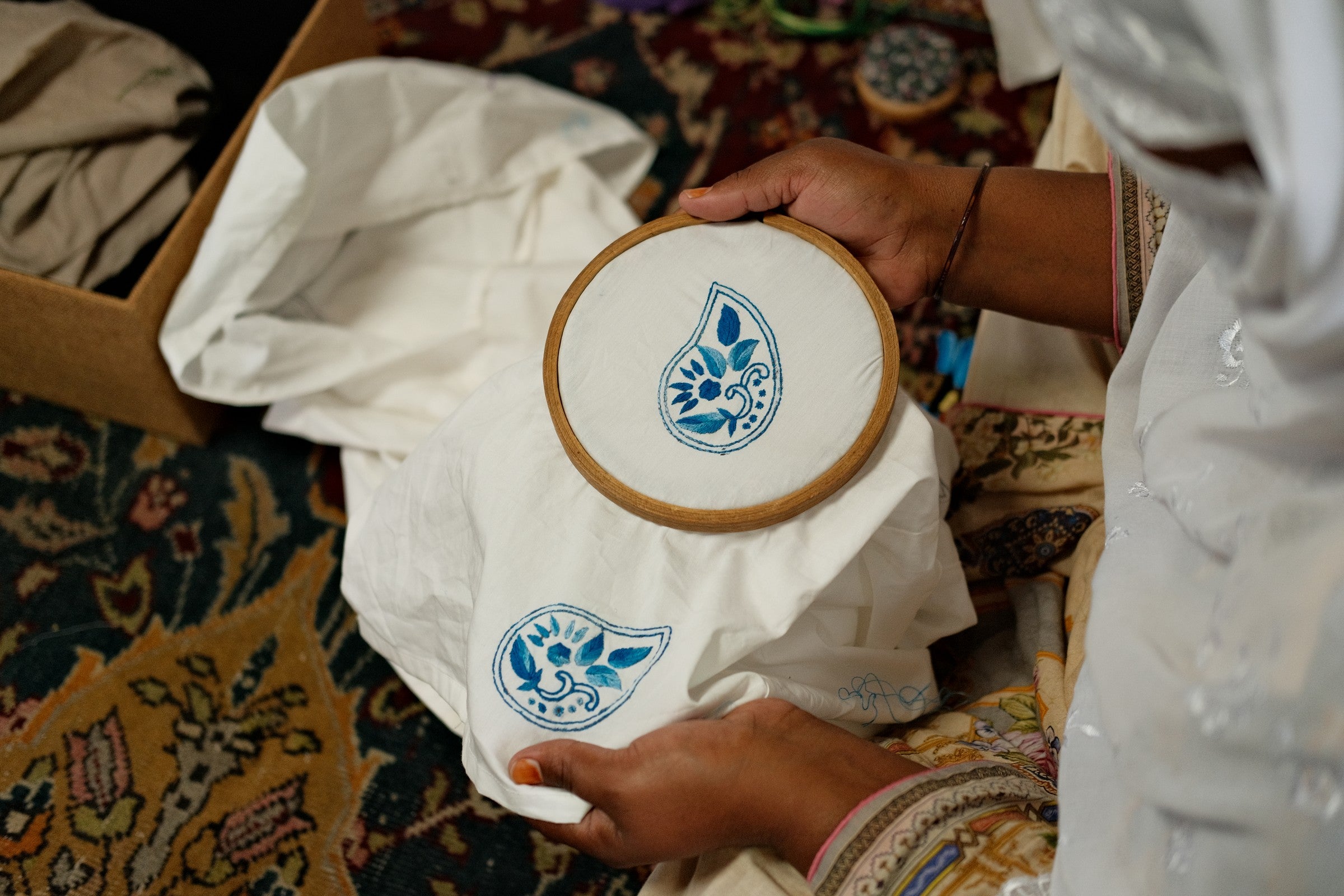 Close-up of paisley hand embroidery in a hoop